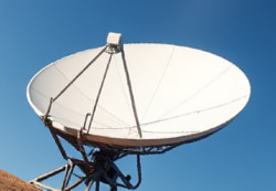 Parabolic satellite dish focusing incoming signals to a central point