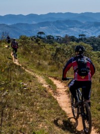 Bicycle on a path with rolling hills representing peaks and valleys