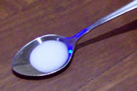 One milliliter of milk in a teaspoon