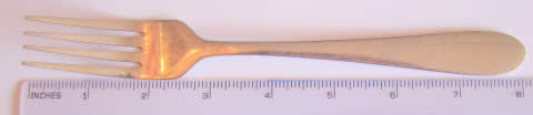 Silver fork next to a ruler showing it is 8 inches long