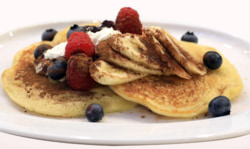 Stack of pancakes with syrup and butter